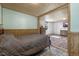 Comfortable bedroom with wood-look flooring, a queen size bed, and an adjacent seating area at 577 Dixon Rd # D, Willow Springs, NC 27592
