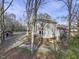 Aerial view of a two-story home with a red metal roof and wooden deck, surrounded by trees at 577 Dixon Rd # D, Willow Springs, NC 27592