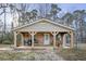 Charming covered porch featuring wooden supports and country-style decorations at 577 Dixon Rd # D, Willow Springs, NC 27592