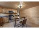 Kitchen featuring wood cabinets, stainless steel appliances, and an island with seating at 577 Dixon Rd # D, Willow Springs, NC 27592