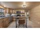 Cozy kitchen with wood-paneled walls, cabinets, and stainless steel appliances and eat in bar at 577 Dixon Rd # D, Willow Springs, NC 27592