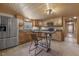 Country style kitchen with stainless steel appliances, natural wood cabinets and bar table at 577 Dixon Rd # D, Willow Springs, NC 27592