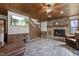 Comfortable living room with stone fireplace, wood paneling and stairs to the second floor at 577 Dixon Rd # D, Willow Springs, NC 27592