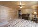 Charming living room featuring natural wood walls, hardwood floors, and warm ambient lighting at 577 Dixon Rd # D, Willow Springs, NC 27592