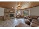 Cozy living room with stone fireplace, bay window, and leather furniture set at 577 Dixon Rd # D, Willow Springs, NC 27592