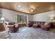 Comfortable living room with stone fireplace, bay window and plush leather furniture at 577 Dixon Rd # D, Willow Springs, NC 27592