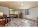 Spacious living area features wood-style flooring, seating, and a light-filled bedroom view at 577 Dixon Rd # D, Willow Springs, NC 27592