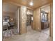 Cozy living space features wood paneling and entryways to the kitchen, bathroom, and bedroom at 577 Dixon Rd # D, Willow Springs, NC 27592