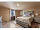 Relaxing main bedroom with wood-look flooring, a plush bed, and bright natural light at 577 Dixon Rd # D, Willow Springs, NC 27592