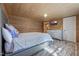 Well-lit main bedroom with wood-look flooring, a queen bed, and a modern dresser at 577 Dixon Rd # D, Willow Springs, NC 27592