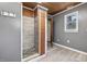 Modern shower boasts decorative tile, gray walls, and a wood ceiling, creating a clean and refreshing space at 577 Dixon Rd # D, Willow Springs, NC 27592