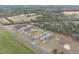 Aerial view shows house with green lawns, mature trees, and a long driveway at 582 Ebenezer Church Rd, Coats, NC 27521