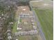 Picturesque view of home surrounded by flowering trees, set on acres of farmland adjacent to state highway at 582 Ebenezer Church Rd, Coats, NC 27521
