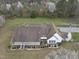 Aerial view of a charming house with manicured front yard, green lawn and long driveway at 582 Ebenezer Church Rd, Coats, NC 27521