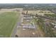 Aerial view shows house with green lawns, mature trees, and a long driveway at 582 Ebenezer Church Rd, Coats, NC 27521