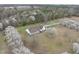 Aerial view features house with brown roof, surrounded by blossoming trees and green lawns at 582 Ebenezer Church Rd, Coats, NC 27521