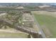 Charming farm house with storage building among blooming trees and bordered by cultivated fields at 582 Ebenezer Church Rd, Coats, NC 27521
