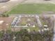 Aerial view features home with lawns, trees, buildings, and a long driveway at 582 Ebenezer Church Rd, Coats, NC 27521