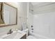 Cozy bathroom featuring a sink with modern fixtures, a full bathtub, and a decorative mirror at 582 Ebenezer Church Rd, Coats, NC 27521