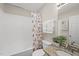Clean bathroom features a tub/shower combo, granite counters, and neutral colors at 582 Ebenezer Church Rd, Coats, NC 27521