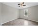 Bright bedroom featuring hardwood flooring, a window, and a ceiling fan at 582 Ebenezer Church Rd, Coats, NC 27521