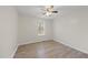 Bright bedroom featuring hardwood flooring, a ceiling fan, and natural light at 582 Ebenezer Church Rd, Coats, NC 27521