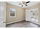 Bedroom with neutral walls, window view, and access to another room, creating a flexible space at 582 Ebenezer Church Rd, Coats, NC 27521