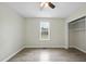 Bright bedroom with hardwood flooring, a window, a ceiling fan, and closet at 582 Ebenezer Church Rd, Coats, NC 27521