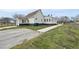 Rear exterior view of a house with a long driveway and green lawn at 582 Ebenezer Church Rd, Coats, NC 27521