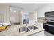 Kitchen island boasts a stainless steel sink and faucet with granite countertops and stainless steel appliances at 582 Ebenezer Church Rd, Coats, NC 27521