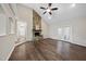 Open-concept living area with a stone fireplace, hardwood floors, and access to the backyard at 582 Ebenezer Church Rd, Coats, NC 27521