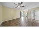 Open living room with hardwood floors, ceiling fan, and access to sliding glass doors for natural light at 582 Ebenezer Church Rd, Coats, NC 27521