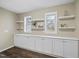 Room featuring custom built-ins for storage, two windows for natural light, and modern floating shelves at 582 Ebenezer Church Rd, Coats, NC 27521