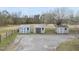 Exterior view of three storage sheds with a gravel driveway and fenced field at 582 Ebenezer Church Rd, Coats, NC 27521