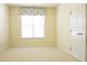 Bright bedroom features neutral carpet, and a window with charming valance at 8504 Lasilla Way, Raleigh, NC 27616