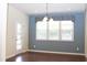 Bright dining area with hardwood floors, a large window, and stylish lighting at 8504 Lasilla Way, Raleigh, NC 27616