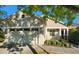 Charming home featuring a beige exterior, attached garage, and lovely front yard landscaping at 8504 Lasilla Way, Raleigh, NC 27616