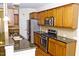 Well-equipped kitchen with stainless steel appliances, granite countertops, and ample cabinet space at 8504 Lasilla Way, Raleigh, NC 27616
