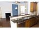 Kitchen bar with granite countertops, stainless steel appliances, and an open view of the living area at 8504 Lasilla Way, Raleigh, NC 27616