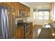 Kitchen showcasing stainless steel appliances, granite countertops, and wood cabinets at 8504 Lasilla Way, Raleigh, NC 27616