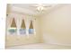 Bright primary bedroom with plush carpet, a ceiling fan, and natural light at 8504 Lasilla Way, Raleigh, NC 27616