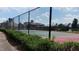 Fenced tennis court in a community setting with landscaped greenery, and other community amenities at 8504 Lasilla Way, Raleigh, NC 27616