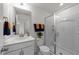 Bright bathroom featuring a glass-enclosed shower, white vanity, and neutral wall paint at 8620 Secreto Dr, Raleigh, NC 27606