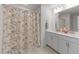 Bathroom with double vanity and floral patterned shower curtain at 8620 Secreto Dr, Raleigh, NC 27606