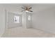 Bright bedroom with neutral carpet, ceiling fan, two windows, and a round window at 8620 Secreto Dr, Raleigh, NC 27606