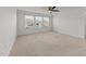 Cozy bedroom featuring neutral carpet, a ceiling fan, and ample natural light at 8620 Secreto Dr, Raleigh, NC 27606