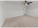 Well-lit bedroom featuring neutral carpeting and a ceiling fan at 8620 Secreto Dr, Raleigh, NC 27606