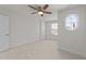 Bright bedroom with neutral carpet, ceiling fan, oval window and one standard window at 8620 Secreto Dr, Raleigh, NC 27606