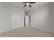 Bedroom with neutral carpet, double door closet, and access to additional rooms at 8620 Secreto Dr, Raleigh, NC 27606