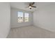 Bright bedroom featuring neutral carpet, a ceiling fan, and a view to the outside at 8620 Secreto Dr, Raleigh, NC 27606